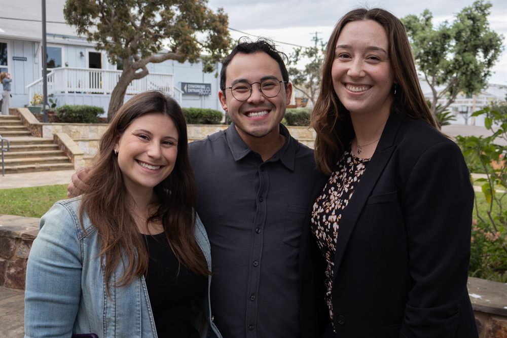 Three young adults at a Federation gathering